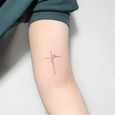 dainty floral cross tattoo